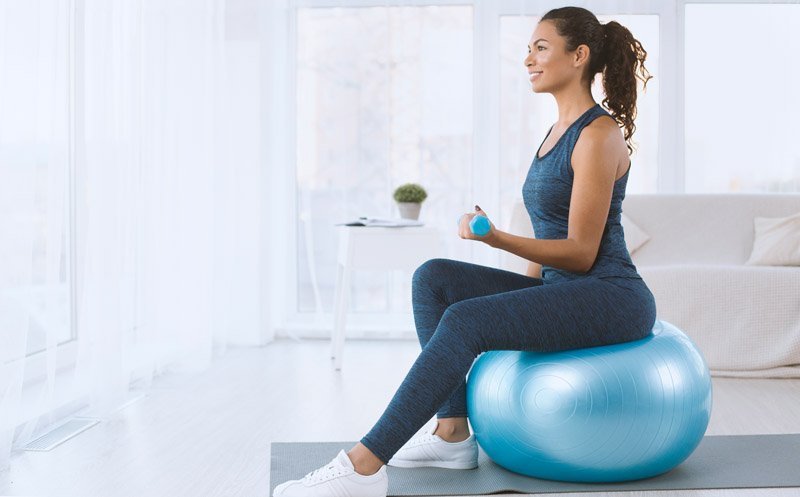 attractive-hispanic-lady-with-dumbbells-sitting-on-GEBTG2G.jpg